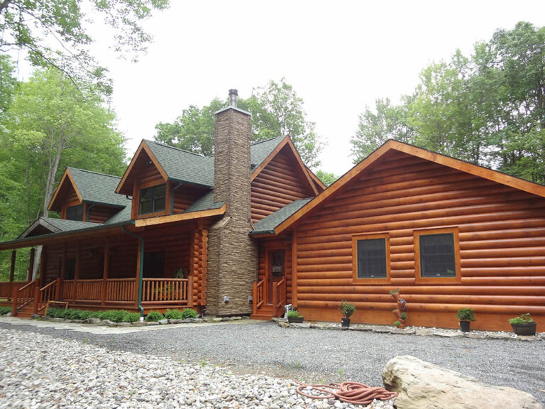 Exterior log home with stone chimney