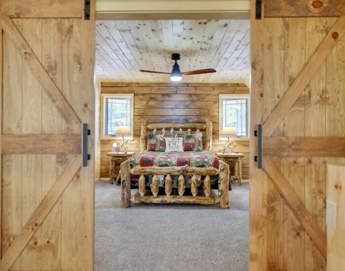 Log home bedroom with sliding doors